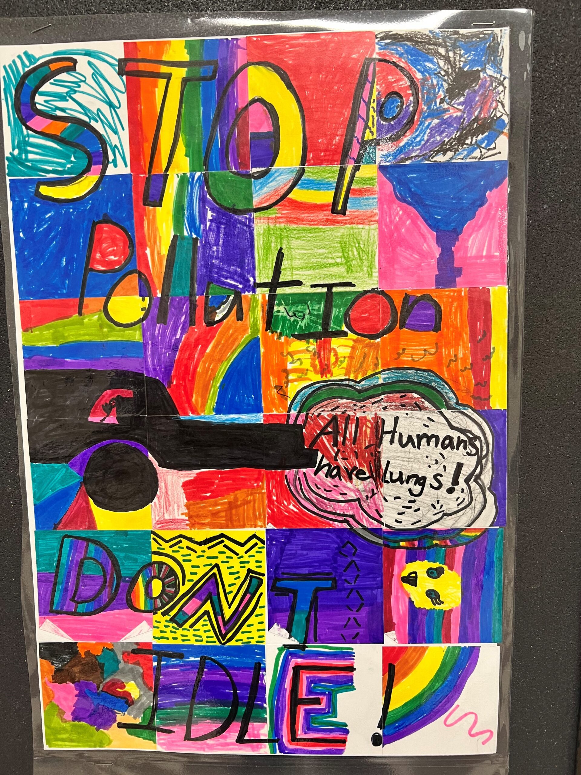 A colorful poster made by children that has a drawing of a car and the words Stop Pollution